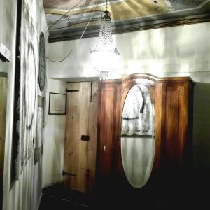 um quarto com uma porta de madeira e um espelho em Studiocasarte em Ovada