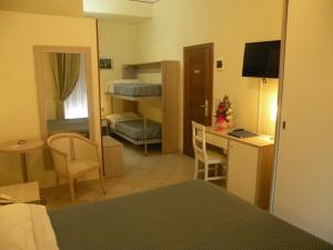 Postel nebo postele na pokoji v ubytování Hotel Parrini