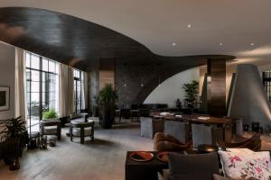a lobby with couches and tables in a building at Kimpton La Peer Hotel West Hollywood, an IHG Hotel in Los Angeles