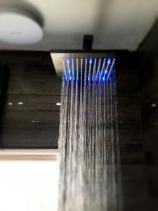 a shower with blue water hanging from the ceiling at Spacious double bedrooms sharing new bathroom, en-suite option available, Kings Lynn in Kings Lynn