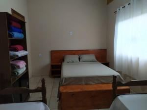 Ένα ή περισσότερα κρεβάτια σε δωμάτιο στο casa temporada capitólio