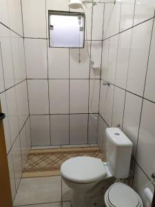 a small bathroom with a toilet and a window at casa temporada capitólio in Capitólio