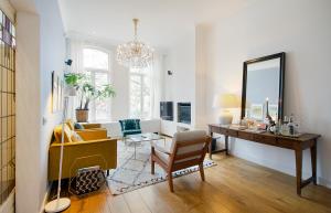 a living room with a desk and a mirror at Luxurious Canal Apartment in Amsterdam