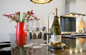 
a table topped with wine glasses and a vase filled with flowers at Luxurious Canal Apartment in Amsterdam
