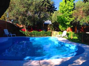 a swimming pool in the backyard of a house at Cabañas Calderón I in San Rafael