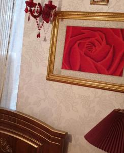 a picture of a red rose on a wall at Квартира в центре Сочи в первых домах от моря с евродизайнерским ремонтом in Sochi