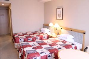 Postel nebo postele na pokoji v ubytování Grand Hotel Hakusan