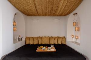 a room with a bed with a table in it at Above Blue Suites in Imerovigli