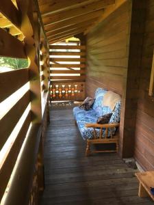 a room with a couch in a wooden cabin at B&B Casa PerAria in Paluzza