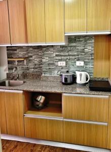 a kitchen with a sink and a counter top at ANIA CONDO STAY in Mactan