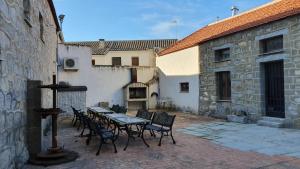 a patio with a table and chairs in a courtyard at Fabrica de Harina in Ventas con Peña Aguilera
