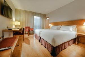 a hotel room with a large bed and a large window at Hesperia Zaragoza Centro in Zaragoza