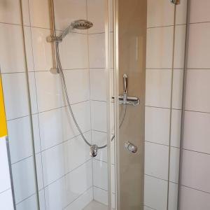 a shower with a glass door in a bathroom at Ferienwohnung Müller in Bestwig +22 photos