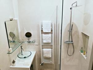a bathroom with a shower and a sink and a mirror at Palazzo Cairney in Nard&ograve;