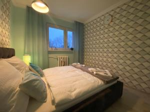 Posteľ alebo postele v izbe v ubytovaní Blue Sky Apartament