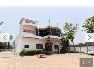 a building with a bench in front of it at vindhyvasini guest house in Kushinagar