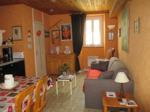 ein Wohnzimmer mit einem Sofa und einem Tisch in der Unterkunft La Clé Des Champs in Villiers-les-Hauts