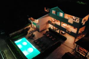 - une vue de tête sur un bâtiment avec piscine la nuit dans l'établissement Villa Bobic, à Kraj