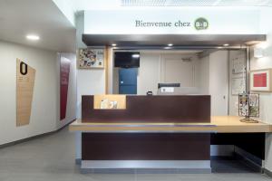 a reference desk in a dental office with a mirror at B&B HOTEL Montlhery in Linas