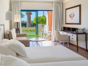 a bedroom with a bed and a living room at H10 Playa Esmeralda - Adults Only in Costa Calma +37 photos