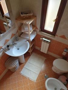 a bathroom with a sink and a toilet at Mary House in Ladispoli