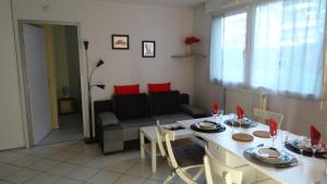 a kitchen and living room with a table and chairs at Appart T2 standing tout confort au calme - parking en option in Lyon