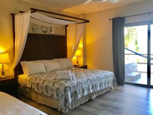 a bedroom with a bed with a canopy at Hotel Playa La Media Luna in Isla Mujeres
