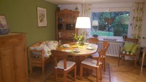 a dining room with a table and chairs and a window at Hoffmanns-Hof-Sinspert in Reichshof 