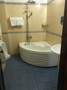 a bathroom with a tub and a sink at Bao Long Hotel in Ho Chi Minh City +48 photos