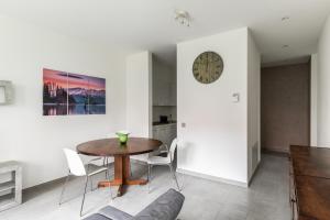 a kitchen and dining room with a table and chairs at Prestige Apartments - spacious flats with terraces in Lugano