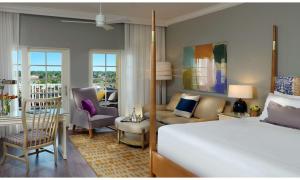 a bedroom with a bed and a living room at La Playa Beach & Golf Resort, a Noble House Resort in Naples