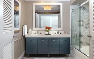 a bathroom with a blue vanity and a shower at La Playa Beach & Golf Resort, a Noble House Resort in Naples
