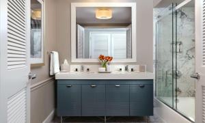 a bathroom with a blue vanity and a shower at La Playa Beach & Golf Resort, a Noble House Resort in Naples