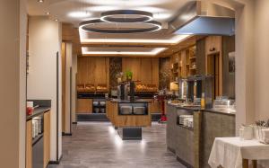 a large kitchen with wooden cabinets and appliances at Der Rindererhof in Tux