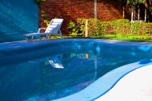 a chair sitting next to a swimming pool at Cabañas Calderón I in San Rafael