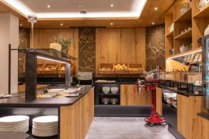 a kitchen with wooden cabinets and a counter with plates at Der Rindererhof in Tux