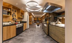 a large kitchen with wooden cabinets and a long counter at Der Rindererhof in Tux