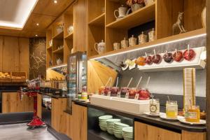 a restaurant with a counter with food on it at Der Rindererhof in Tux