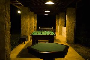 a room with a pool table in a cave at Pousada Chácara Das Acácias in Paraty