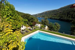 a swimming pool with a view of a lake at Lakeview Geres Guest House in Geres