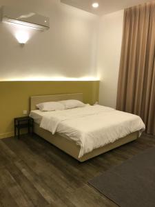 a bedroom with a large bed with white sheets at platinum Chalet Mirbat in Salalah