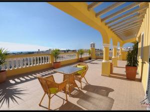 een patio met een tafel en stoelen op een balkon bij Villa Sesmarias Lux is a Luxury villa with private swimming poolm sea-views and AC in Carvoeiro