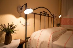 a bedroom with a bed with a lamp next to it at Country House S'Ozzastru in Dorgali