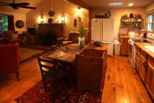 a kitchen with a table with chairs and a refrigerator at Lake Rabun Hotel in Lakemont