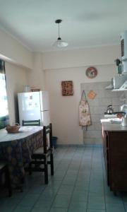 a kitchen with a table and a refrigerator at Departamento Centro Villa Carlos Paz in Villa Carlos Paz +2 photos
