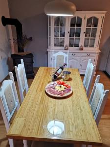 a wooden table with a plate of food on it at Comfort apartment with garage Aria in Vrgorac