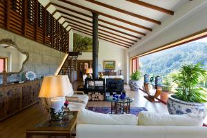 a living room with a white couch and a large window at Lakeview Geres Guest House in Geres