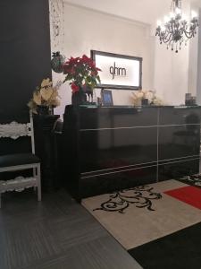 a living room with a dresser and a mirror at A New Guesthouse in Pavia