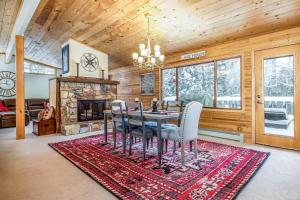a dining room with a table and chairs and a fireplace at Vance Bay Getaway in Manitowish Waters
