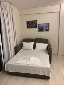 a bed with white sheets and pillows in a room at Salinas Park Resort in Salinópolis